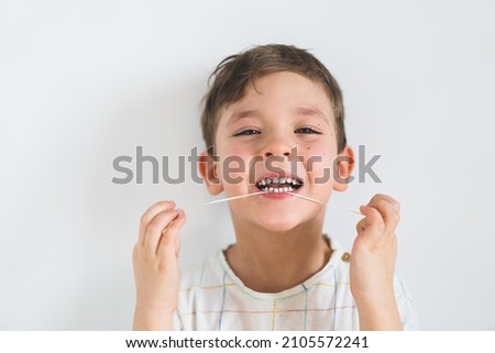 Similar – Image, Stock Photo Child flossing face and tiring milk tooth to pull out