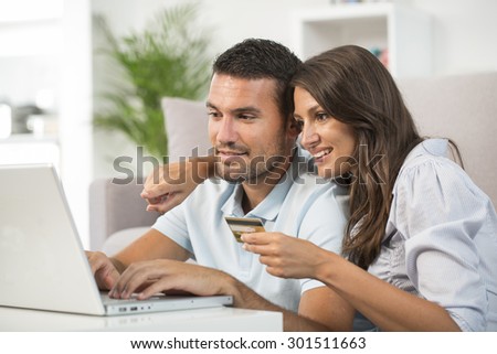 Couple using credit card to shop on line