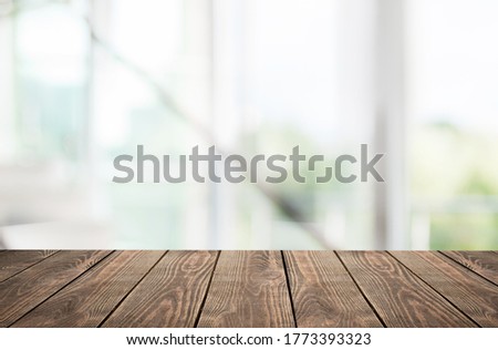 Wooden empty table top in front of blurred window background Stockfoto © 