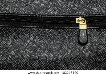 Zip fastener on black leather bag