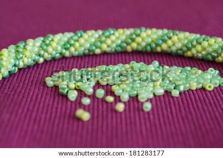 Knitted necklace and the scattered beads close up
