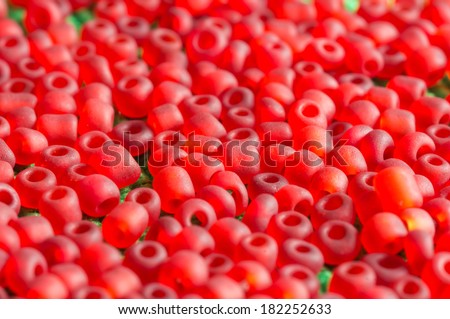 The scattered beads of red color close up