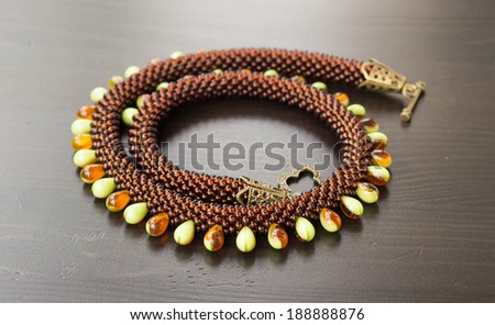 Knitted necklace from different types of beads