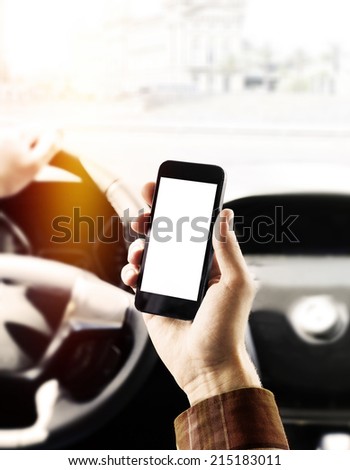 Man holding phone in car
