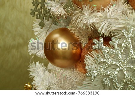 close up of a shiny pink gold ball shaped christmas ornament with blurred silver - Pink And Gold Christmas Decorations close up of a shiny pink gold ball shaped christmas ornament with blurred silver - Pink And Gold Christmas Decorations