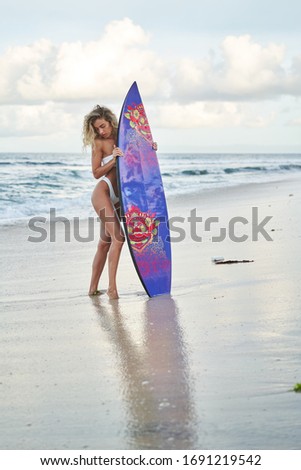 Similar – Image, Stock Photo Anonymous female surfer walking on beach with surfboard