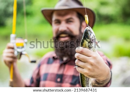 Fishing. Angler with fishing trophy. Fisherman and trout. Fishing backgrounds. Man hold big fish trout in his hands. Fisherman and trophy trout. Man holding a trout fish. ストックフォト © 