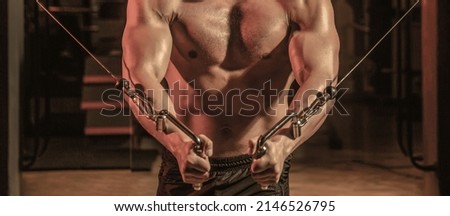 Abs and biceps. Fitness man execute exercise with exercise-machine Cable Crossover in gym. Handsome man with big muscles in gym. Machine in the gym. Stock foto © 