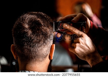 Image, Stock Photo Hands of a barber washing the head with shampoo to a client with the head resting on the sink