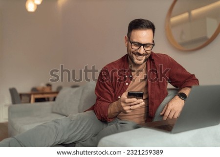 Similar – Image, Stock Photo Happy man reading message on smartphone