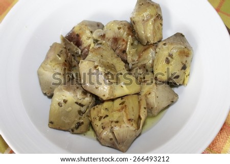 Artichoke hearts covered in herbs served as an appetizer