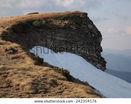 Carpathian mountains in spring. Faded grass and melting snow