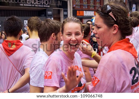 PAMPLONA, SPAIN -JULY 6: Young women are having fun at the opening of the San Fermin festival. Plaza in front of municipality. Pamplona, Navarra, Spain 6 July 2012 in Pamplona Spain.
