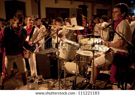 PAMPLONA, SPAIN-JULY 9: Young people are having fun with the music rock band at San Fermin festival. Pamplona, Navarra, Spain 9 July 2012 in Pamplona Spain.