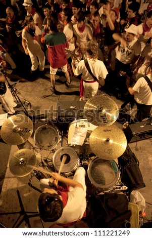 PAMPLONA, SPAIN-JULY 9: Young people are having fun with the music rock band at San Fermin festival. Pamplona, Navarra, Spain 9 July 2012 in Pamplona Spain.