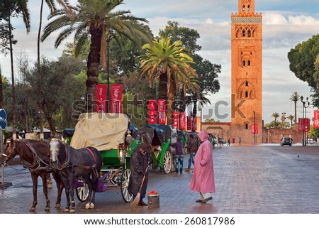 MARRAKECH, MOROCCO - NOVEMBER 30: Cab drivers in horse-drawn carriages around Koutoubia mosque awaiting tourists in Marrakech, Morocco, November 30, 2014. Marrakech popular place among tourists.
