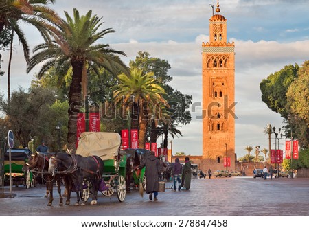MARRAKECH, MOROCCO - NOVEMBER 30: Cab drivers in horse-drawn carriages around Koutoubia mosque awaiting tourists in Marrakech, Morocco, November 30, 2014. Marrakech popular place among tourists.