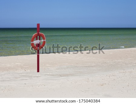 Life bouy, life belt hanging on post. Sandy beach in VÃ?Â?Ã?Â¤Ã?Â?Ã?Â¤na-JÃ?Â?Ã?Âµesuu river mouth in Estonia. Baltic sea.