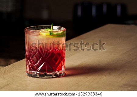 Similar – Image, Stock Photo Red alcohol cocktail with black olive and whiskey lemon cocktail