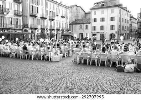 ALBA, ITALY/CUNEO - JUNE 20: A flash-mob, named \'white dinner\', performed by many people with all white dresses in the old city centre of Alba (Piedmont, Northern Italy). Alba (CN), June 20, 2015.