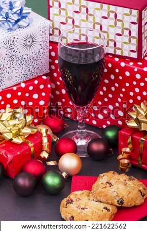 Christmas Cookies, Red Wine and Presents A selection of wrapped Christmas gifts and decorations, some of the gifts are hand crafted with a glass of red wine and two Cookies