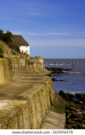 Runswick Bay Sea Wall\
Runswick Bay is a rocky secluded bay on the North Yorkshire coast. This shows the sea wall with a thatched holiday cottage at the end.