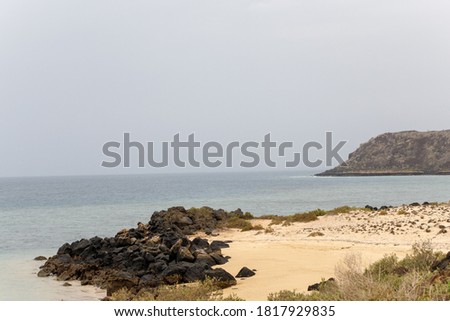 beach with mountains and cliff m in the background Photo stock © 
