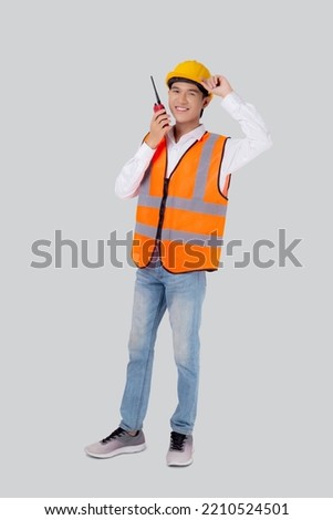 Portrait young asian man is engineer wearing helmet standing and using radio for speak with confident isolated on white background, handsome male is architect or contractor, worker or labor concept. Stockfoto © 