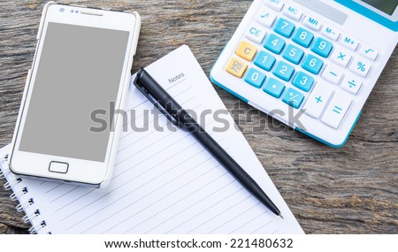 note paper with calculator, mobile, telephone and pen on table, vintage filter
