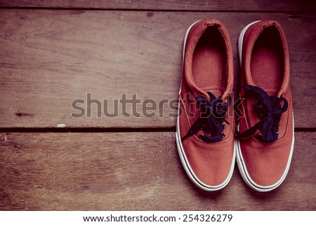 Pair of shoes on a Wooden Background.