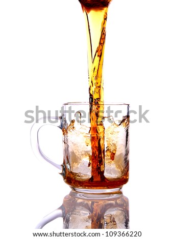 Black tea is poured into a glass cup