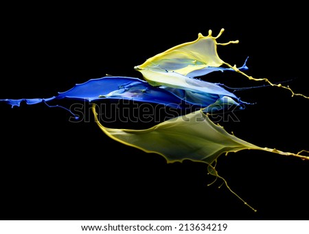impingement of blue and yellow paint on a black background
