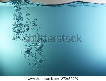 Blue underwater surface and air bubbles