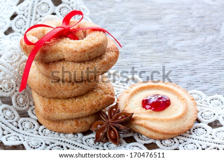 sugar cookies with jam, decorated with a red ribbon