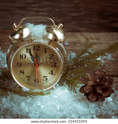 clock on a wooden surface with snow