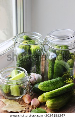  Canned cucumbers, pickled cucumbers Glass jar with pickled cucumbers on a wooden background. Canning of fresh homemade cucumbers. Selective focus. nature