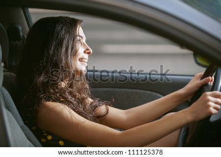 Young woman with nice car on road.