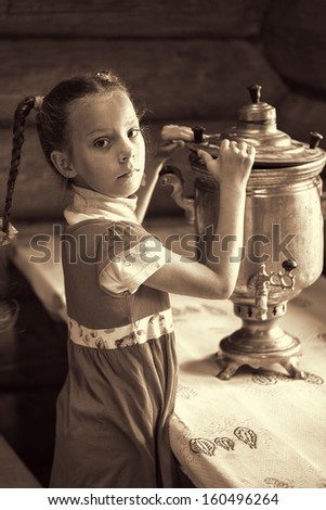 Beautiful little girl with samovar in an old Russian house.