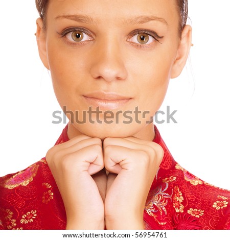 Charming young woman in red Chinese clothes smiles, it is isolated on white background.