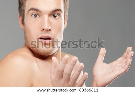 Young man has opened mouth from surprise, isolated on white background.