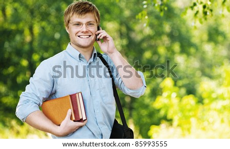 business man wearing glasses bag shoulder talking phone books