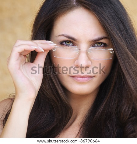 Portrait Of Young Smart Brunette Woman Wearing Eyeglasses Against ...