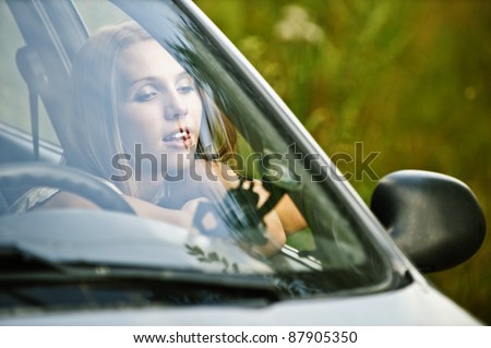 portrait young thoughtful beautiful woman sitting car leaned open window dreams background summer green nature