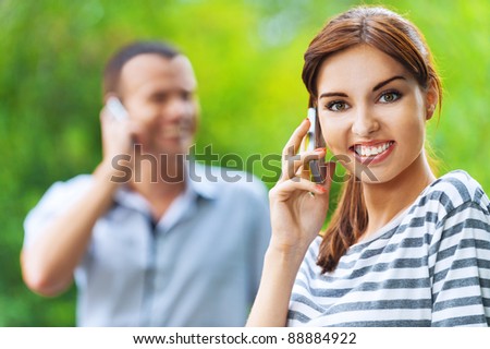 portrait young beautiful happy couple man woman talking phone background summer green park