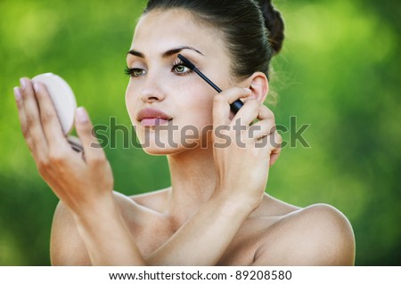 naked woman attractive looks mirror dye eyelashes background summer green park