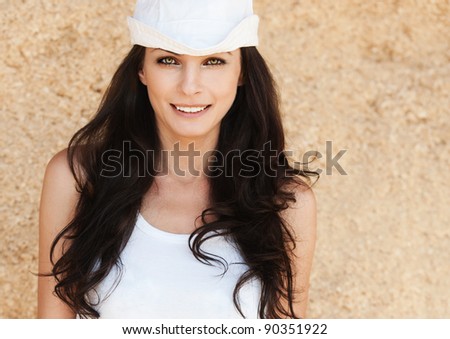 slender long-haired brunette portrait white cap