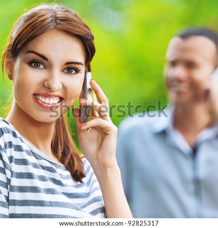 portrait young beautiful happy couple man woman talking phone background summer green park