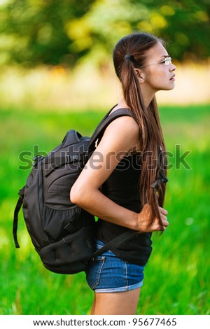Profile attractive woman glasses with backpack, smiling background summer green park