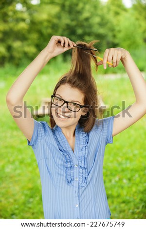 portrait young beautiful girl glasses combs hair smiling background summer green park