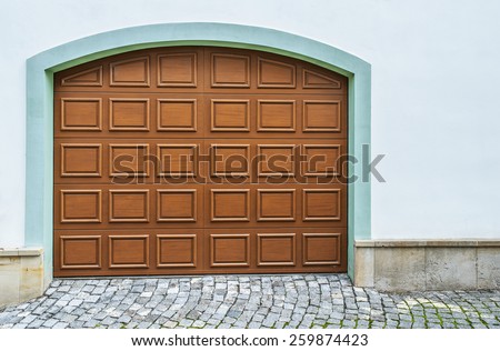 Arched wooden garage doors in a modern house.